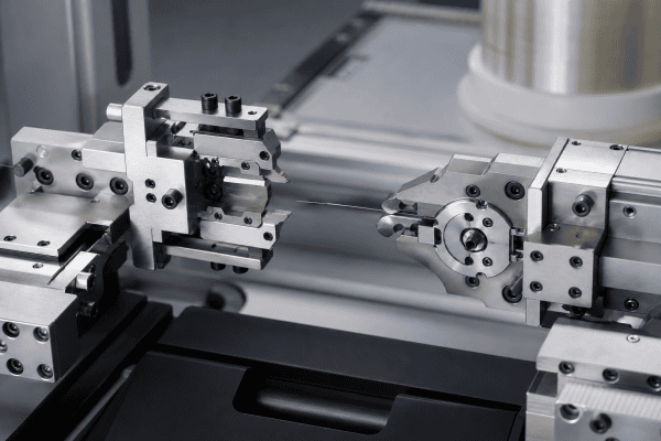 Illustration of Optical Fiber Bobbin Changeover Components: Custom Clamp and Cutter Parts